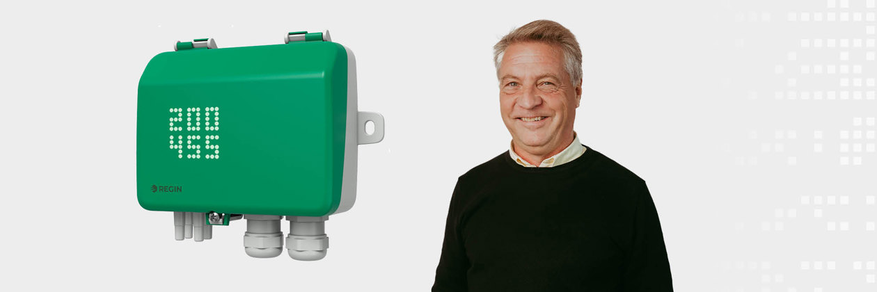 A green device labeled 'Regin' with digital numbers displayed is mounted beside a person in a black sweater.